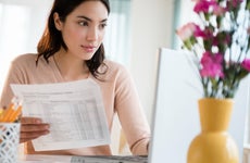 Woman paying bills on laptop