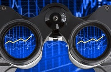 Binoculars showing an investment performance graph in the lenses