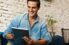 A man researches on a tablet.