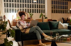 Woman using a laptop on a sofa