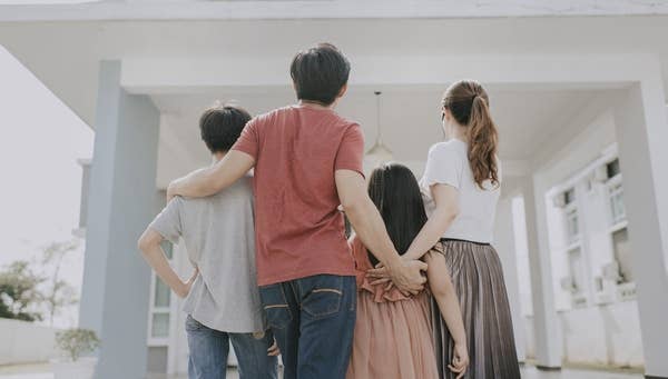 Family standing outside home