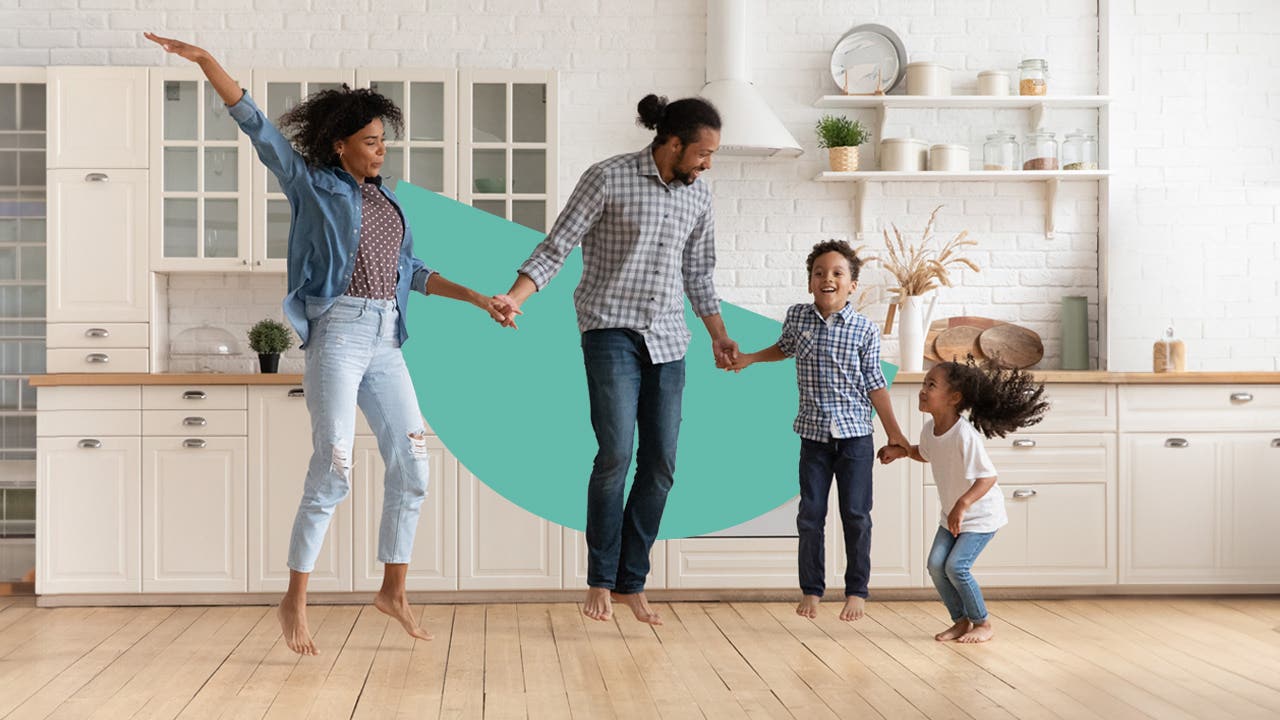 A happy family jumping in a kitchen