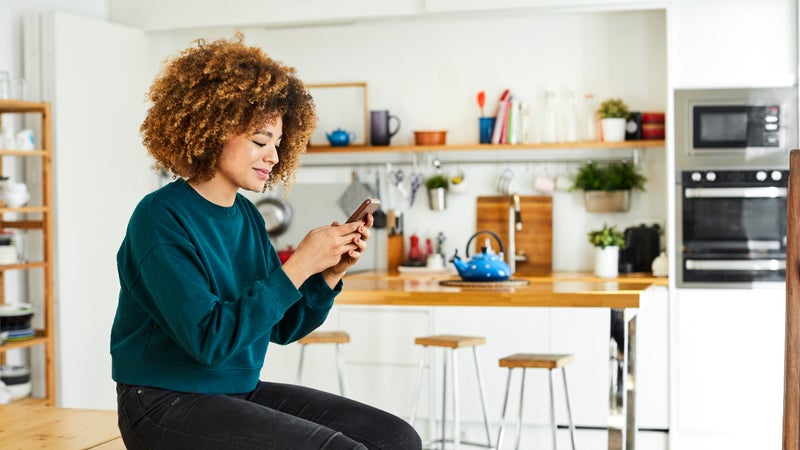 A young woman works on her smartphone.