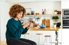 A young woman works on her smartphone.