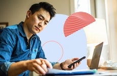 Man working on laptop and cellphone simultaneously