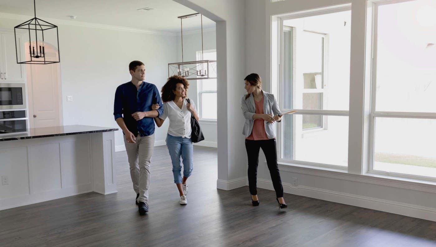 Family walking with realtor inside home