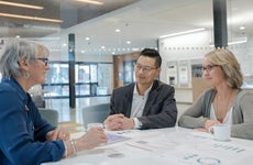 Loan manager meeting with couple in bank branch office