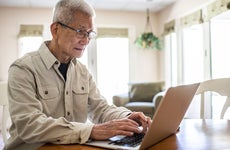 Senior man using laptop computer at home