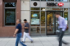 People walking past an HSBC Bank