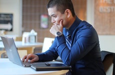 A man works on his laptop.