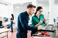 A group of startup business employees working together in a modern office environment.