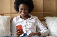 A young female researches on her phone.